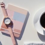 Elegant flat lay with wristwatch, notebook, and coffee, perfect for modern lifestyle themes.